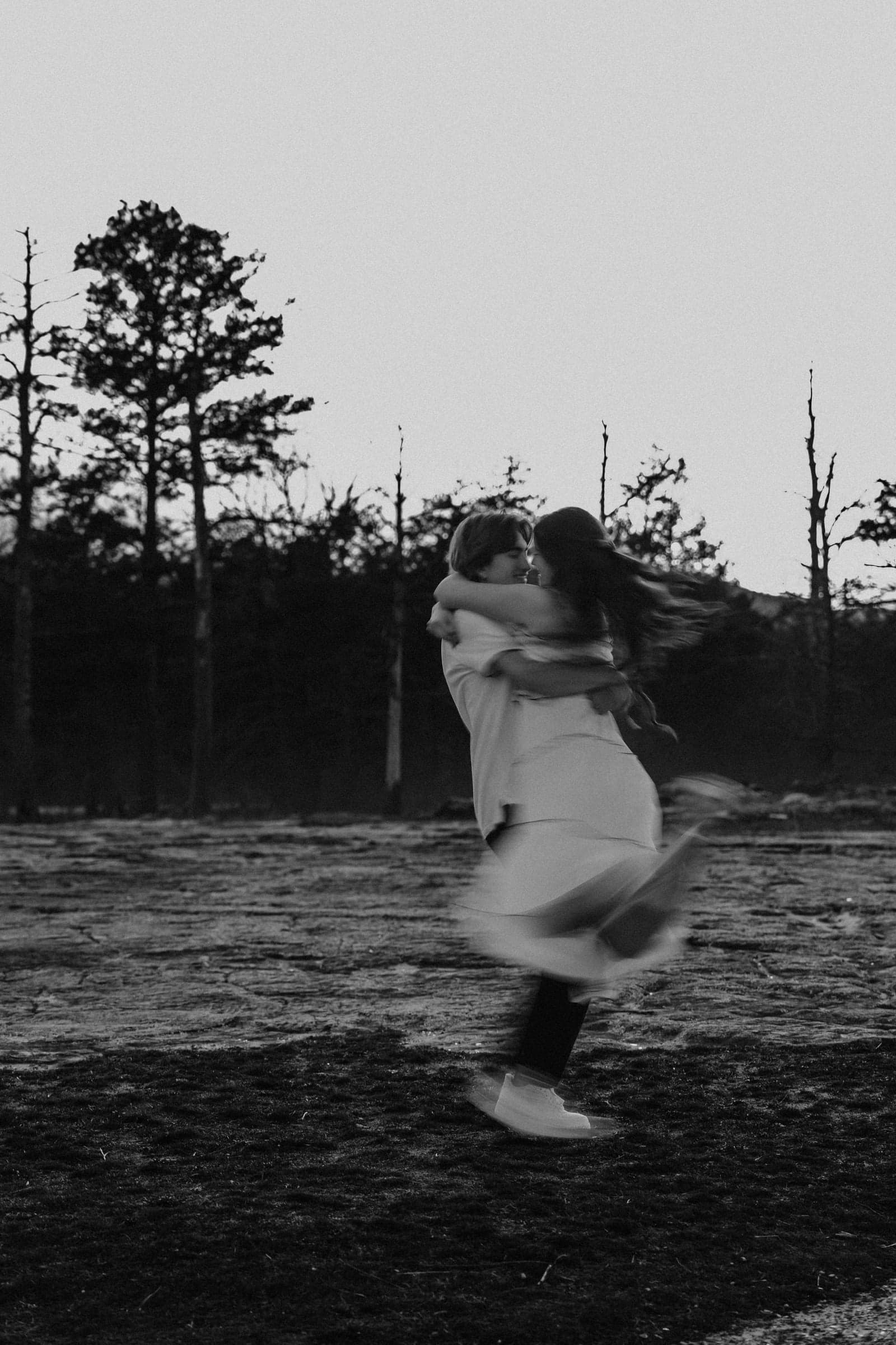 A black and white couple embracing outdoors